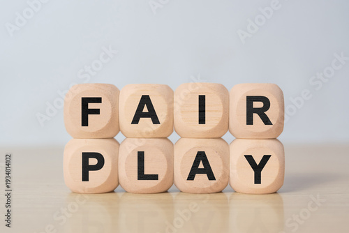 Slika na platnu Cubes and dice with the word fair play on wooden background