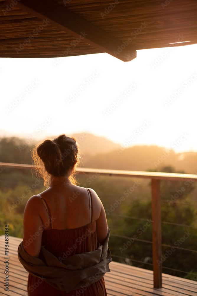 Fototapeta premium Woman Watching Sunset Over Valley