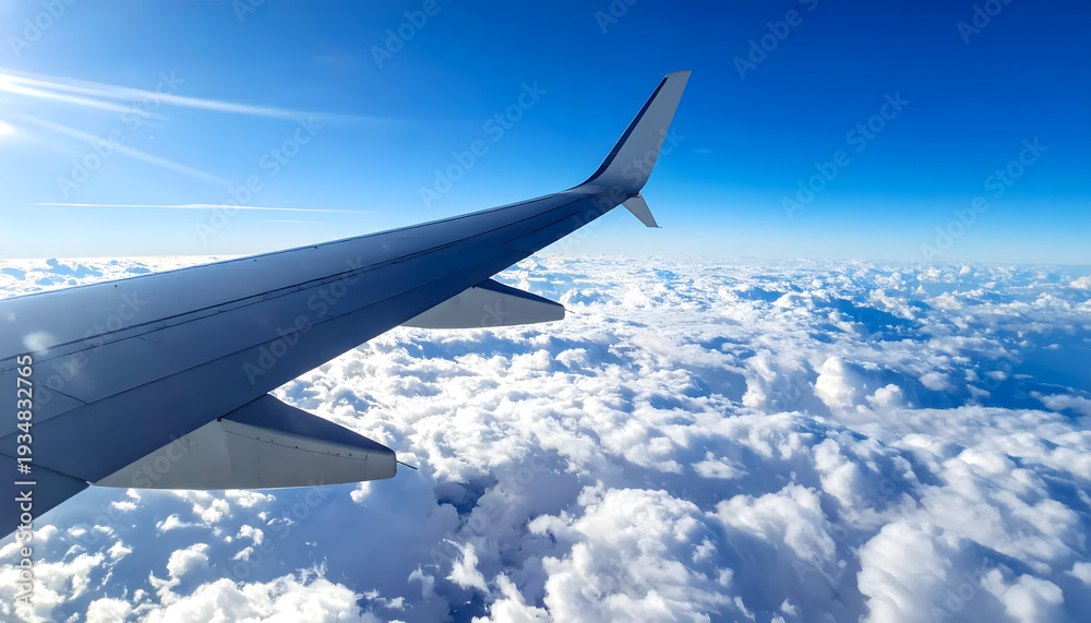 Obraz premium Airplane wing crossing clouds