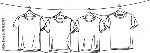 Continuous line drawing of four tshirts hanging on clothes hangers from a clothesline
