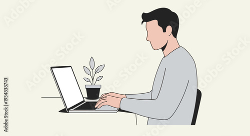 Man sitting at desk working on laptop with plant nearby indoors