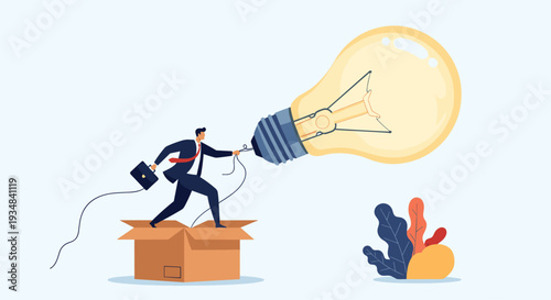Ambitious businessman standing in a cardboard box while trying to connect a giant glowing light bulb as a symbol of creativity and innovation.