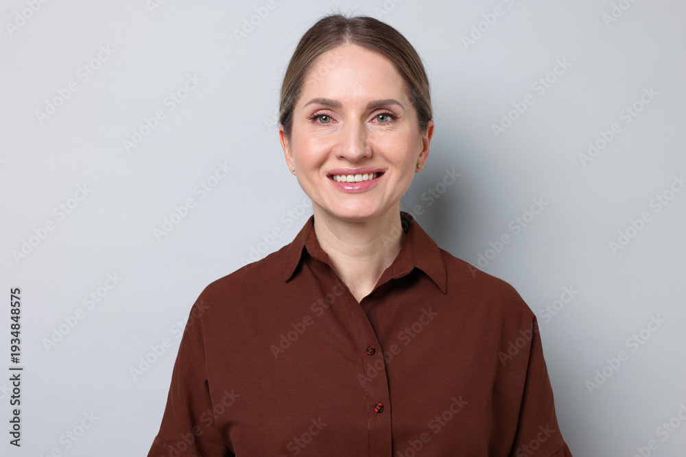 Fototapeta premium Portrait of beautiful woman on light grey background