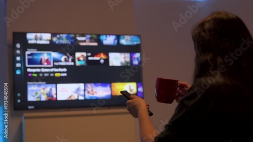 Person browsing streaming service on smart tv at home