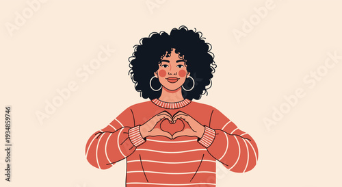 Beautiful young woman with curly hair wearing a striped sweater and making a heart shape with her hands on beige.