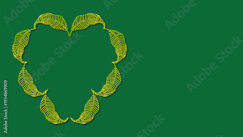 A heart shape formed by leaves arranged in a circular pattern on a green background viewed from directly above
