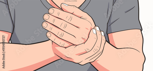 A man is sitting and holding his wrist with both hands while taking a break at work. He looks focused on his discomfort.