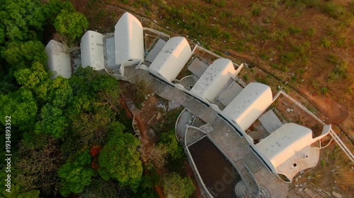Aerial view above a house in middle of autumn color trees - top down, drone shot