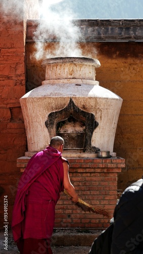White Pagoda and A praying lama burning the incense, Tibet, China