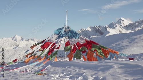 Colorful Tibetan prayer flags flying in the wind with beautiful white snow mountains background, 4k slow motion footage b roll shot.