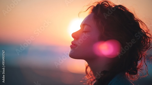 Side Profile of Young Woman with Eyes Closed Enjoying Peaceful Sunset on the Beach