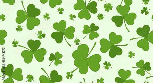 St. Patrick's Day clover shamrock leaf seamless pattern. Seamless pattern of green shamrock clover leaves on pale mint background with soft watercolor texture and subtle paper grain