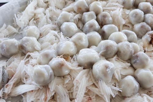 Khanom Tom is a traditional Thai dessert made from glutinous rice flour, filled with grated coconut stir-fried with palm sugar.