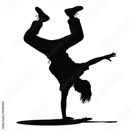 Silhouette of a person performing a handstand breakdance pose