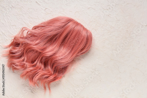 Pink wig on white background