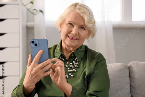 Beautiful senior woman usin...