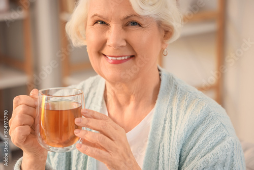 Senior woman with cup of te...