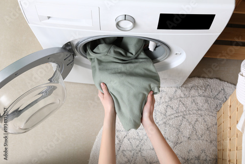 Female hands unloading wash...