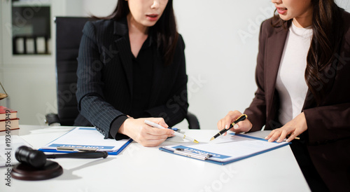 Business and lawyers discussing contract papers with brass scale on desk in office. Law, legal services, advice, justice and law