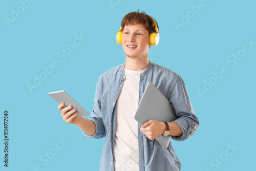 Young man in headphones wit...