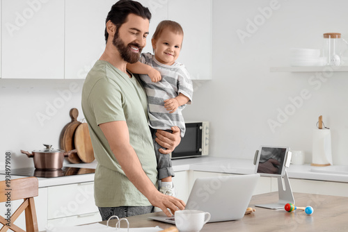 Father working with laptop ...