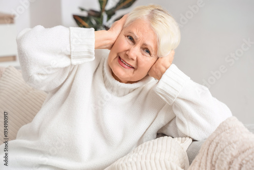Senior woman on sofa suffer...