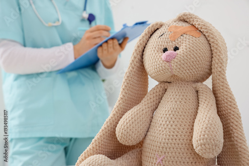 Toy bunny with medical patc...