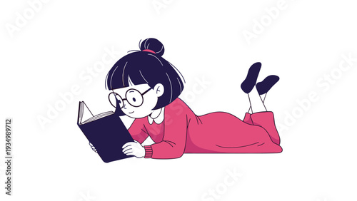 Young girl with dark hair and glasses lying on her stomach and reading an interesting book, wearing a pink dress and dark blue socks on white.