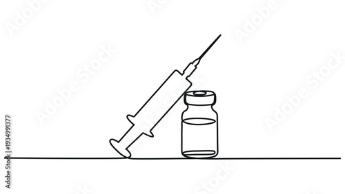 A syringe and a vial on a flat surface