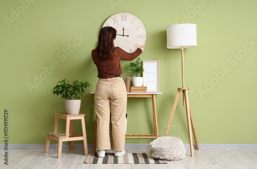 Young woman hanging big clo...