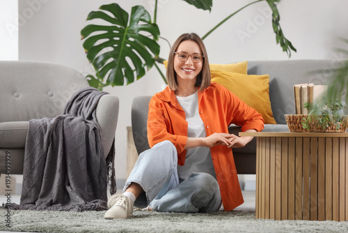 Happy young woman sitting o...