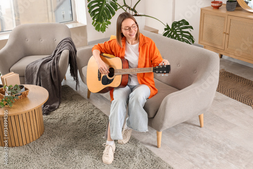Happy young woman playing g...