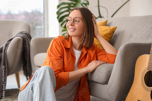 Happy young woman sitting b...