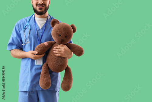 Male pediatrician with toy ...