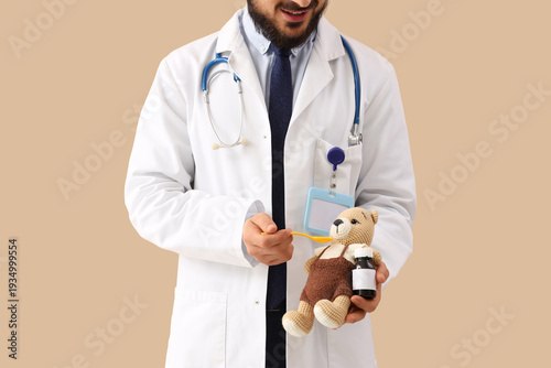 Male pediatrician with toy ...