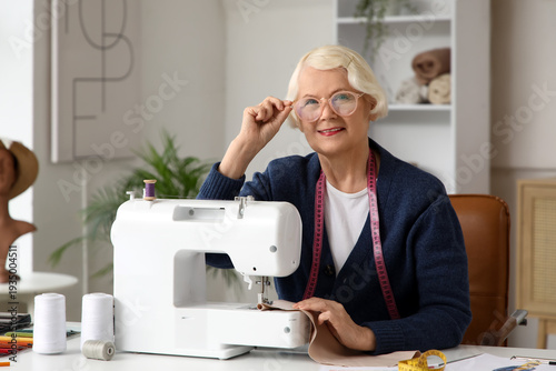Senior female tailor with e...