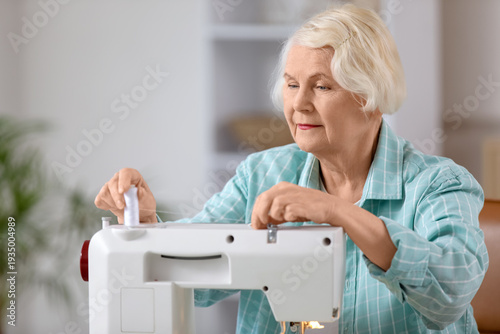 Senior female tailor using ...