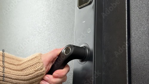A woman opens a modern smart door lock with a digital keypad and biometric fingerprint access.