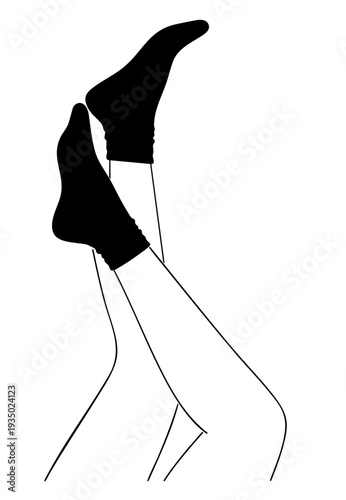 feminine silhouette of slender female legs in a playful pose with black socks
