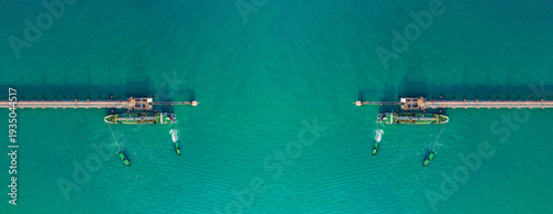 Billede på lærred Aerial top view drone shot of industrial oil tanker docking at offshore pipeline terminal in turquoise ocean water during daylight