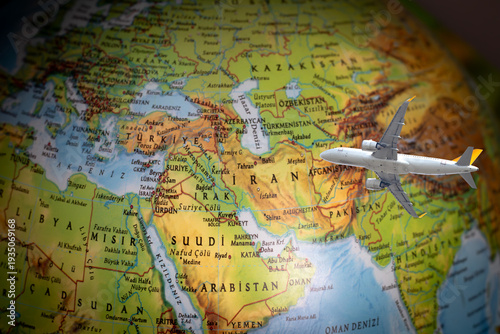 Flight cancellations due to the war. The plane is flying over the map of Iran. War tensions caused flight restrictions. Aviation idea concept. Middle Eastern countries. Travel. No people, nobody. Top 