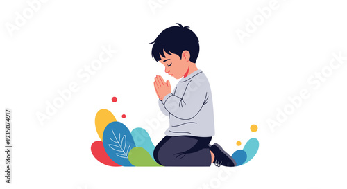 Innocent young boy wearing a grey sweater and dark pants kneels down with closed eyes and folded hands to offer a peaceful prayer.