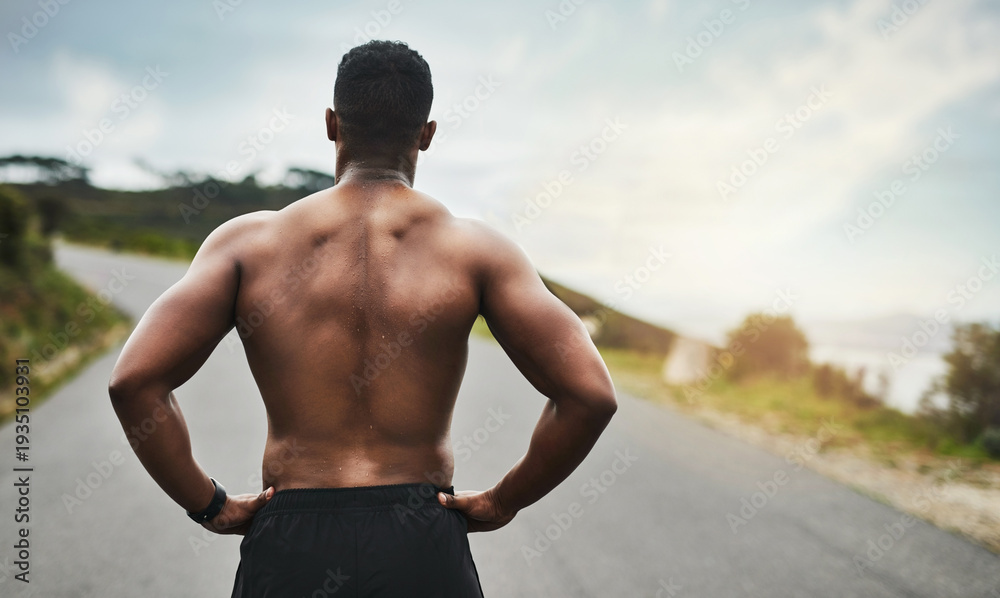 Fototapeta premium Man, back and runner with fitness on mountain road for workout, cardio exercise and view in nature. Male person, athlete and confidence with asphalt, path or street for outdoor endurance training