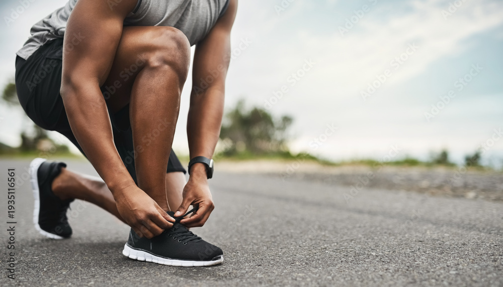 Obraz premium Hands, shoelace and man in street, practice for health benefits and training. Outdoor, athlete and person with sneakers, exercise and fitness for wellness, start day and feet with morning routine