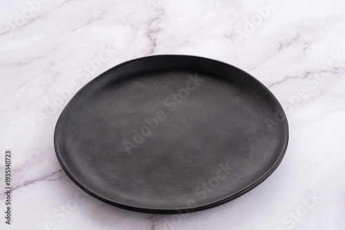 Black Rounded Ceramic Plate Marble Background