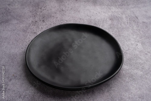 Black Rounded Ceramic Plate Marble Background