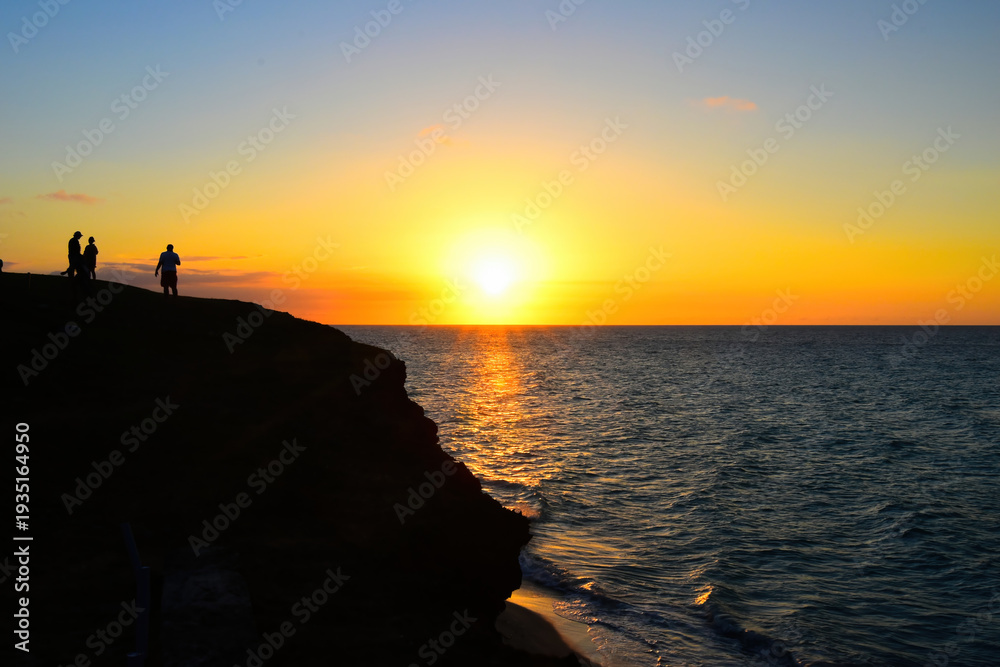 Fototapeta premium Varadero, Cuba; 04.07.2023. Beautiful, colourful sunset on the beach in Varadero, Cuba! Cote d'Azur of the Atlantic Ocean, next to the Caribbean Sea. Cuba wild palm beach background. Nature blue sea l