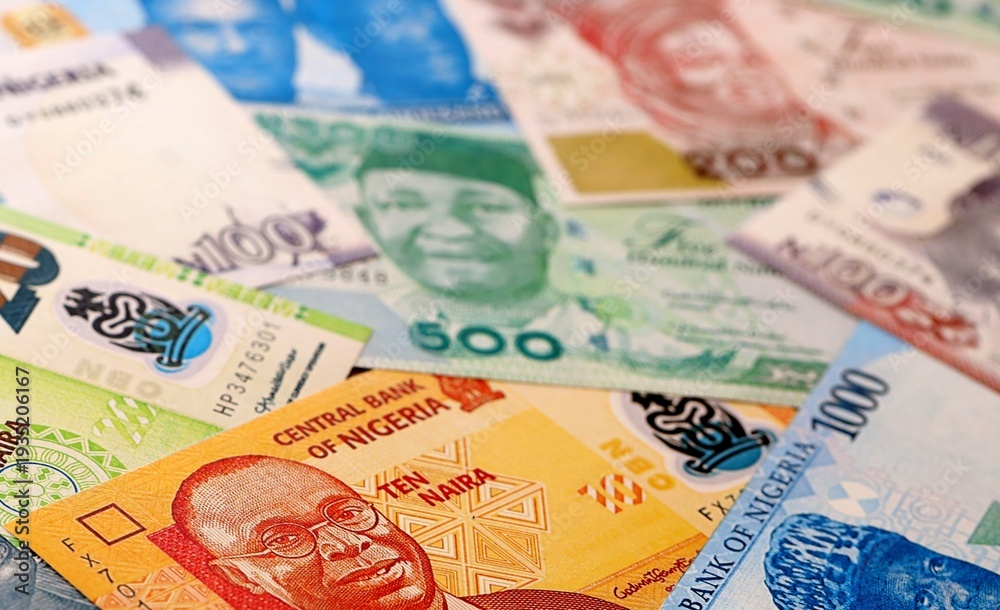 Obraz premium Nigeria naira money bills pile on table. Nigeria banknotes of NGN currency close up.