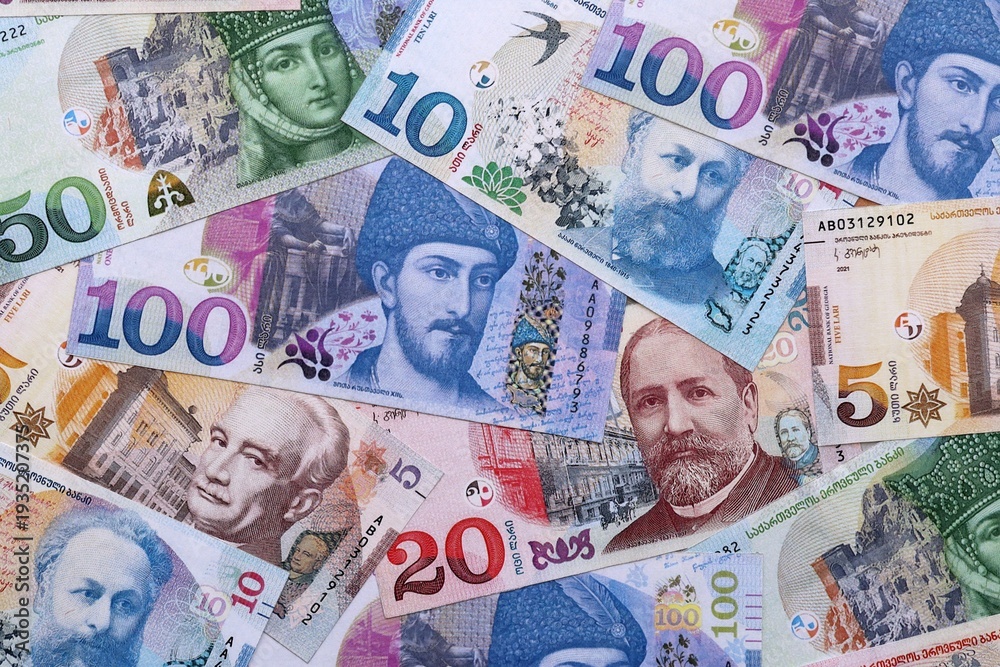 Obraz premium Georgian lari money bills pile on table. Georgia banknotes of GEL currency close up.