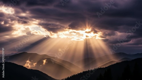 Majestic sunset over mountain range with dramatic clouds and sun rays breaking through